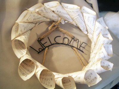 metal welcome sign on a wreath