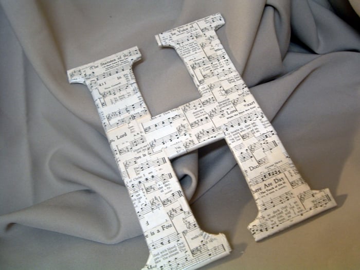 Make this sheet music letter with old cereal boxes! Step by step instructions for making your own DIY chipboard monogram!