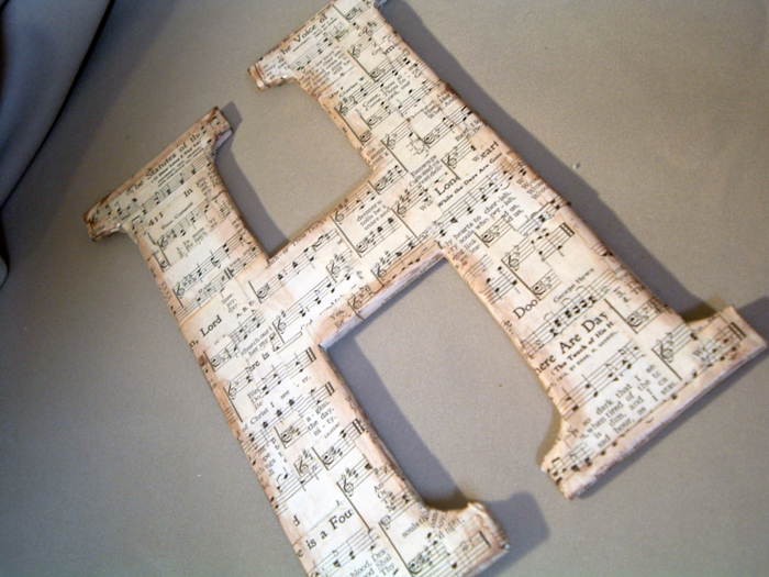 Make this sheet music letter with old cereal boxes! Step by step instructions for making your own DIY chipboard monogram!