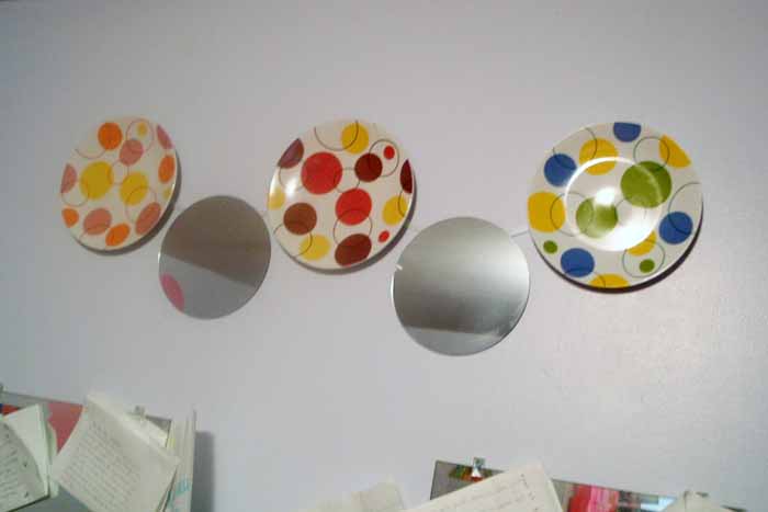 polka dot plates and round mirrors hanging on wall