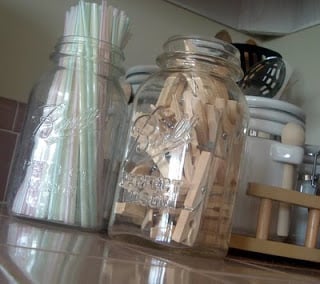 Mason jar full of clothespins on a counter