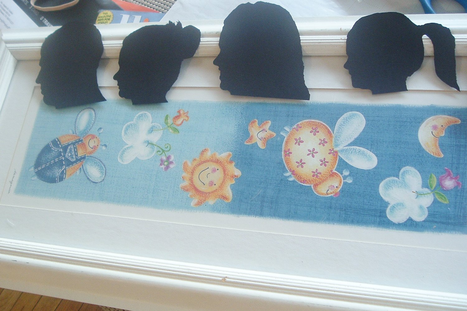 Cricut silhouettes lined up along a white picture frame