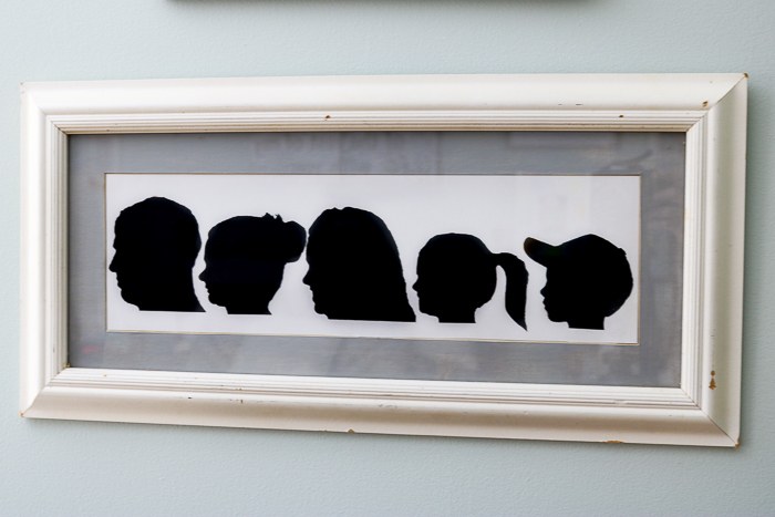 Our family's silhouettes against a white card stock in a white picture frame