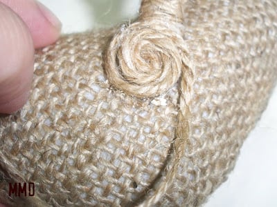 glueing jute swirl onto bird ornament