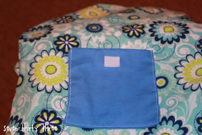 sewing blue pocket onto floral fabric