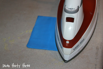 blue fabric pocket being ironed flat