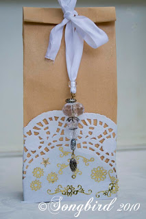 craft bag tied with white ribbon and white doily