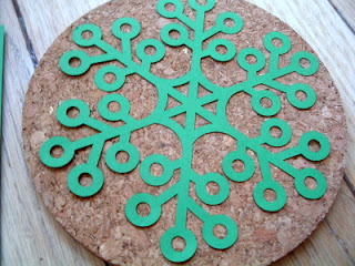 green snowflake stencil on a cork coaster