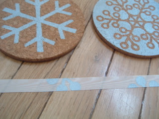 stenciled coasters and ribbon on wood