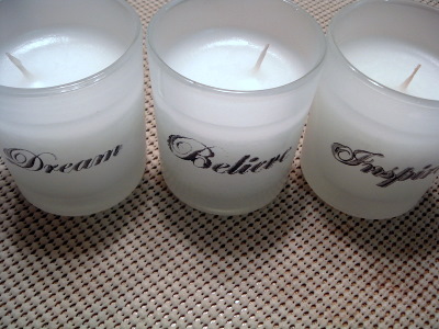 stamped white votive candles on beige mat