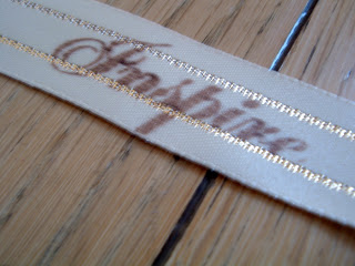 Inspire hand stamped on ribbon
