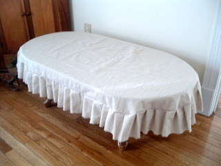 white ruffled slipcover for a coffee table