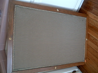 fabric covered bulletin board with wood frame on hardwood floor