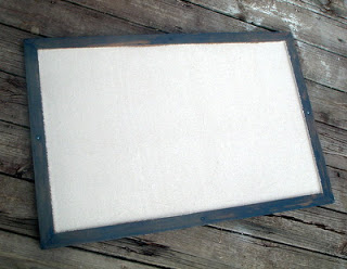 navy and canvas bulletin board on hard wood floor