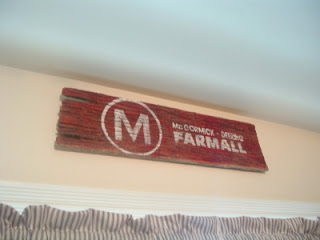 red farm sign with circle m