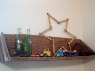wooden shelf with star art and trucks