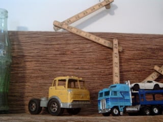 wooden shelves with vintage toy trucks