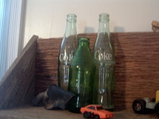 vintage coke bottles on shelf
