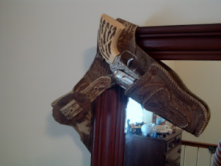 vintage toy gun hanging on dresser