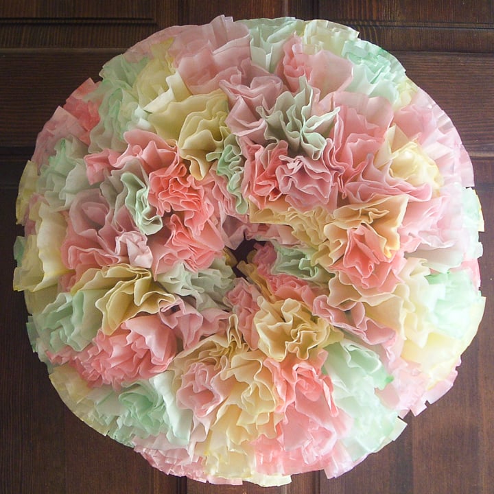 A pastel colored Spring coffee filter wreath is the perfect way to add some color to your Spring decor