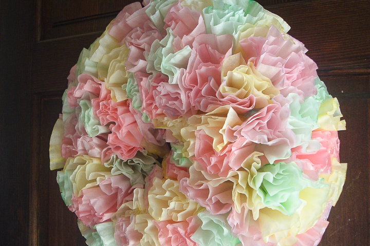 This simple coffee filter wreath is an easy DIY that adds a pop of Spring color to your front door!