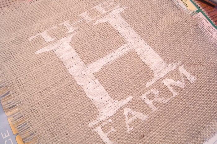 Use the stencil to paint your design onto your burlap sheet