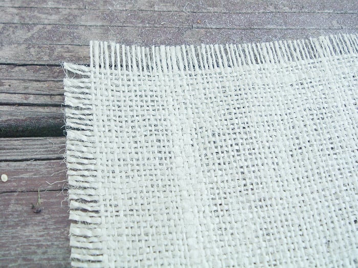 Create frayed edges around your burlap sheet using fray check