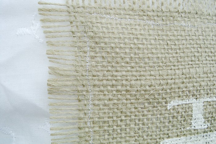 A straight stitch along the outside of the frayed burlap will be enough to secure the burlap to the lace