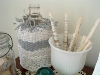 tshirt basket and white pedestal vase with sheet music tubes