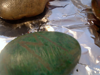 green painted rock with an m