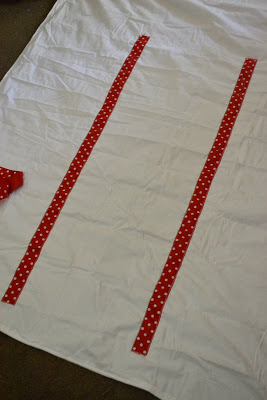 red polka dot ribbon on white sheet