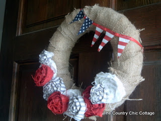 Americana Door Wreath hanging on a dark wood front door