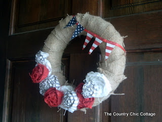 side view of american flag and patriotic wreath hanging on a front door