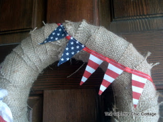 flag pennant banner hanging on wreath on wooden door