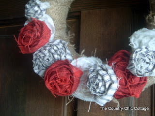 burlap covered wreath form with red white and blue fabric roses close up