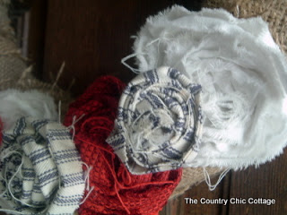 Blue and White Ticking and red fabric roses on a burlap wreath