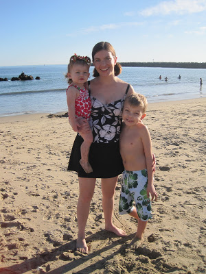 woman with her two kids on a beach