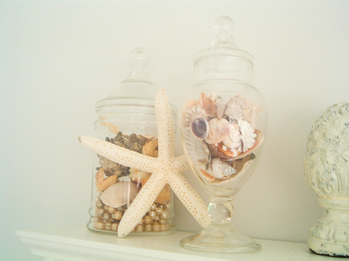 Seashells in jars in a beach theme bathroom are a great thrift store find