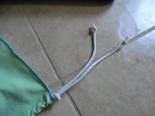 Knot the rope at the ends and along the fabric line to keep the robe secure