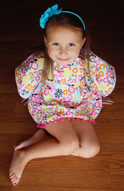 little girl sitting on wood floor