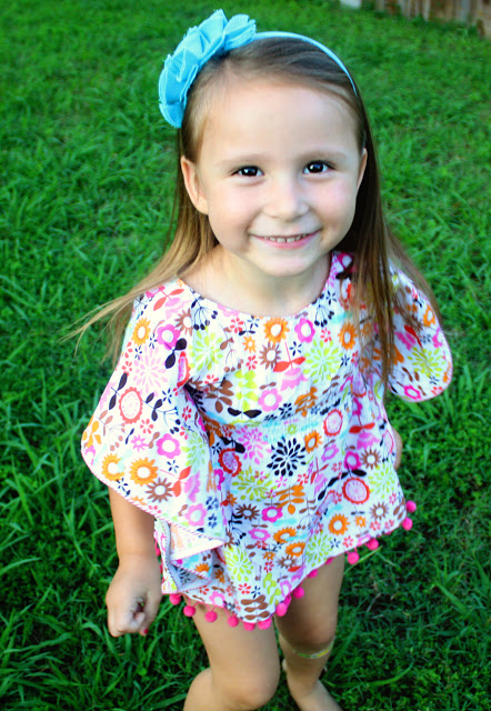 little girl with floral dress on grass