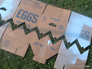 cutting a chevron stencil out of a cardboard box