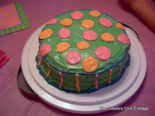 green cake with pink and orange decorations