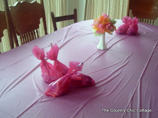 pink treat bags on a party table