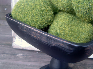 close up of rimmed bowl with moss rocks