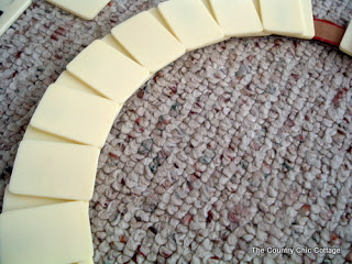 gluing a second layer of Rummikub letters to a wreath form 