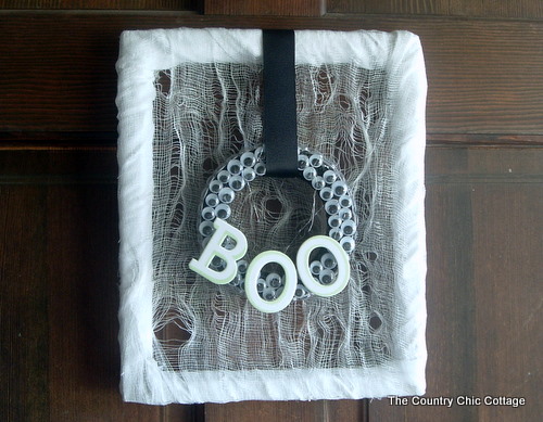 square frame on door with "boo"