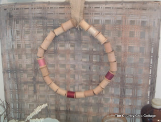 Wooden spool wreath hanging on a tobacco basket