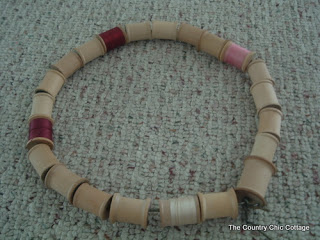 threaded wooden spools on to a wire wreath form