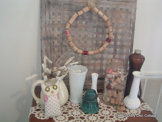 Displaying a wooden spool wreath behind a vintage vignette